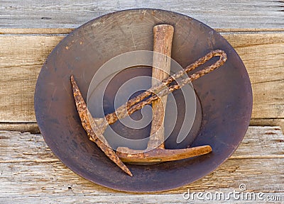 Gold pan holding two old mining picks