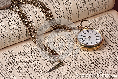 Gold Pocket Watch On Old Bible