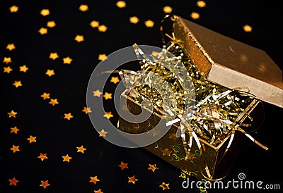 Golden gift box on black background