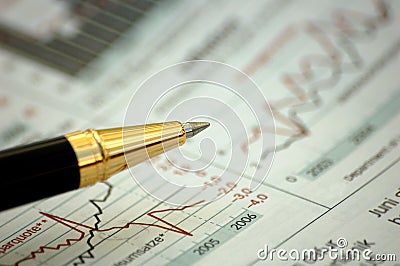 Golden pen showing diagram on financial report