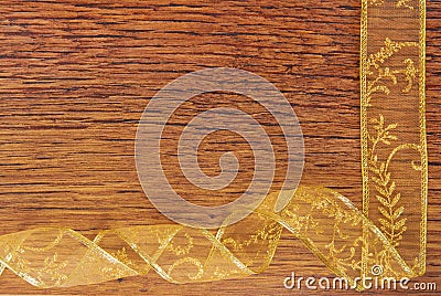 Golden ribbon frame on wood