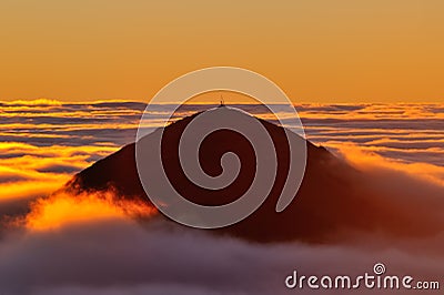 Golden sunrise over the ocean of clouds