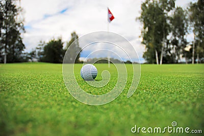 Golf ball in front of flag