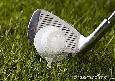 Golf ball on tee with club