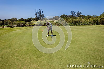 Golf Player Putting Short Hole