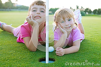 Golf sister girls relaxed laying green hole ball