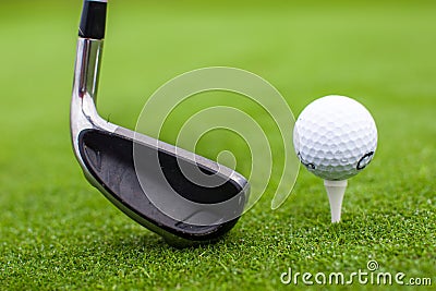 Golf tee ball club driver in green grass course