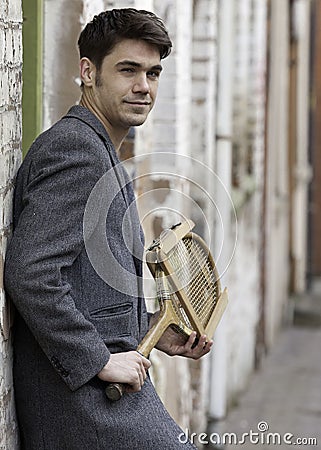 Gorgeous vintage man with a tennis racquet