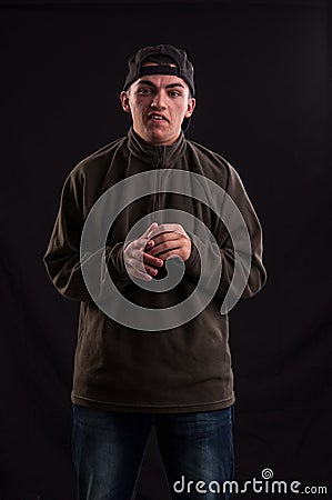 Goofy teenager wearing cap, with a funny expression on hi