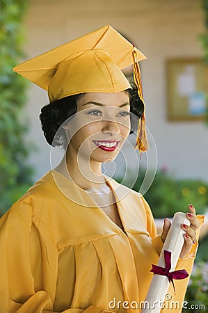 Graduate holding diploma outside
