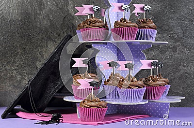 Graduation day pink and purple party cupcakes and large cap.