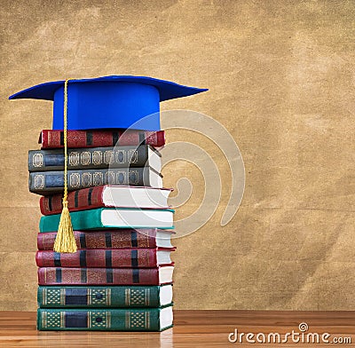 Graduation mortarboard on top of stack of books
