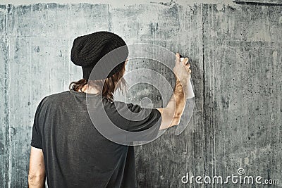Graffiti artist spraying the wall