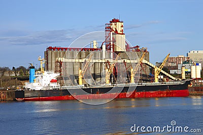 Grain elevators & cargo ship.
