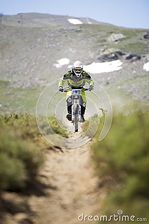 GRANADA, SPAIN - JUNE 30: Unknown racer on the competition of the mountain downhill bike Bull bikes Cup DH 2013, Sierra Nevada