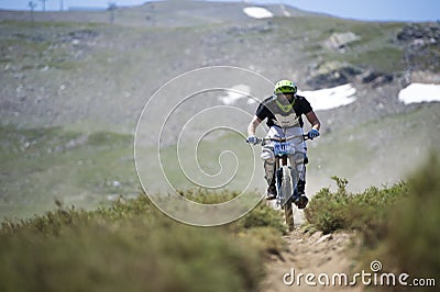 GRANADA, SPAIN - JUNE 30: Unknown racer on the competition of the mountain downhill bike Bull bikes Cup DH 2013, Sierra Nevada