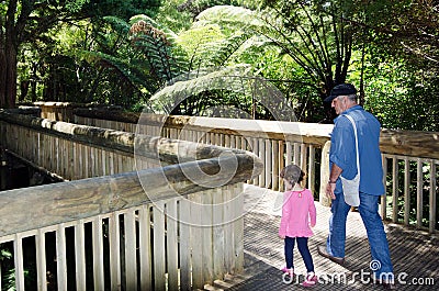 Grandfather walks with his granddaughter