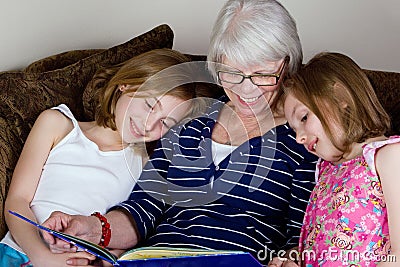 Grandma reading a book to Grand kids