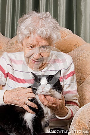 The grandmother with a cat on a sofa