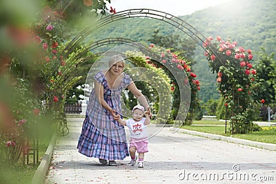 Grandmother teaching little girl to walk