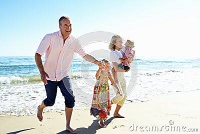 Grandparents And Grandchildren On Beach