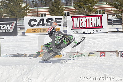 Green Arctic Cat #720 Snowmobile Landing from Jump