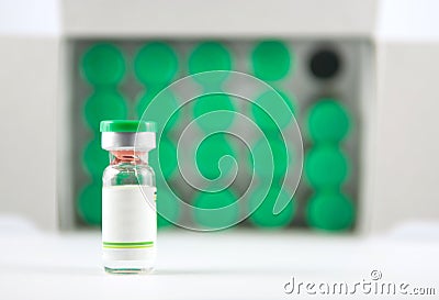 Green cap vial on vial cover background