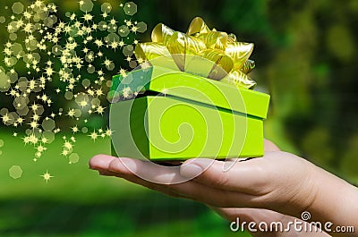 Green Gift box in woman s hands