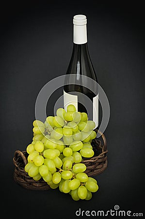 Green grapes and a bottle of wine