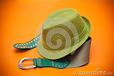 Green hat and a green belt with a buckle in western style