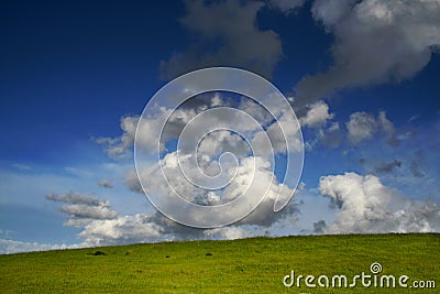 Green hill, blue sky and white clouds