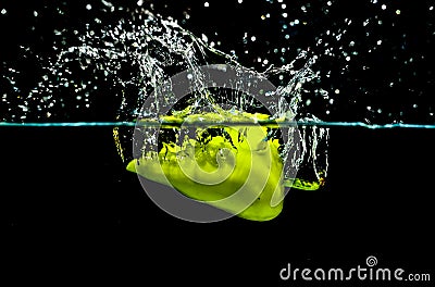Green pepper making water splash