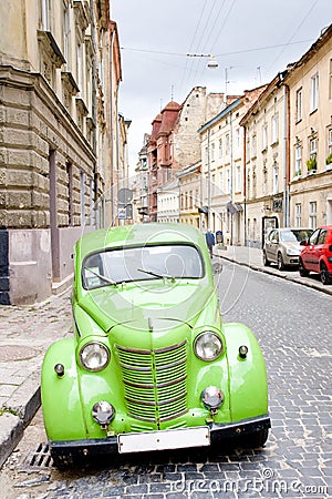 Green retro car on the old streets of Lviv, Ukrain