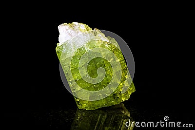 Green tourmaline in front of black