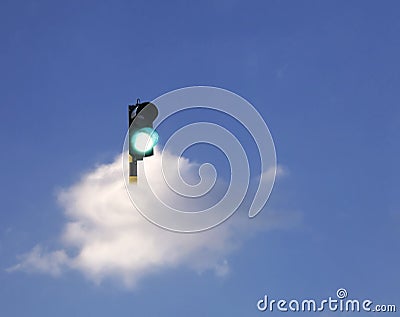 Green traffic lights floating on white clouds