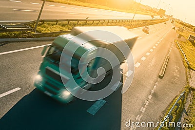 Green truck in motion blur on the highway