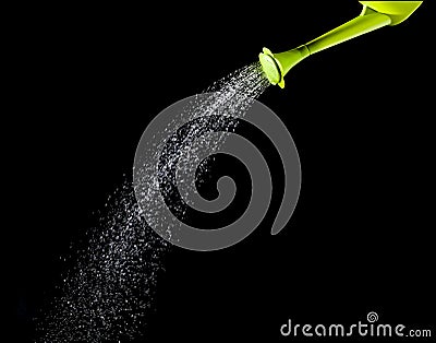 Green watering can pouring water with high speed shutter technic