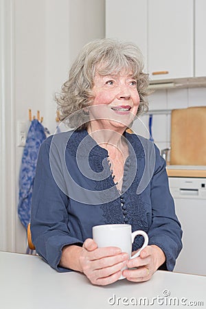 Grey haired woman with mug