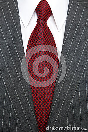 Grey pinstripe suit and red tie