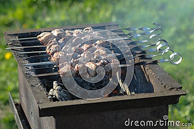 Grill meat on skewers outside the room