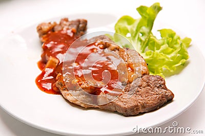 Grilled beef steak with sauce and vegetables