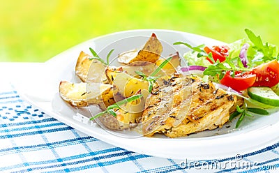 Grilled chicken breast fillet with potatoes and salad