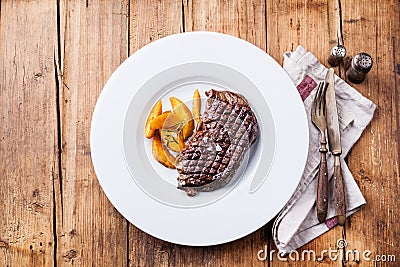 Grilled New York steak with potato wedges