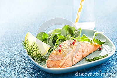 Grilled pink salmon steak with green salad