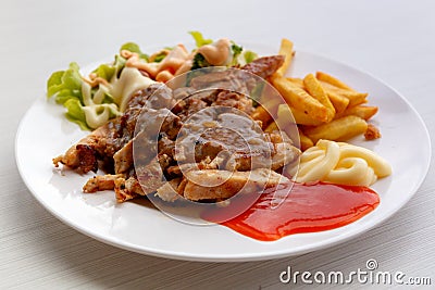 Grilled pork steak with potato and salad