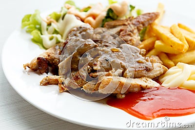 Grilled pork steak with potato and salad