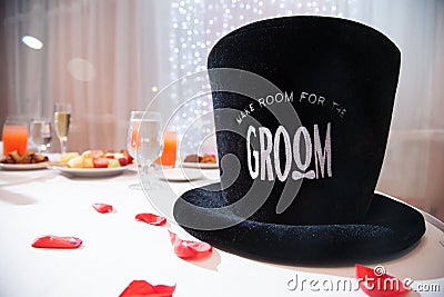 Grooms top hat on table