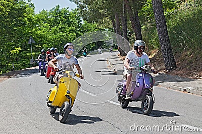 Group of bikers riding a vintage italian scooters