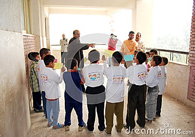Group of boys in circles getting instructions from teacher