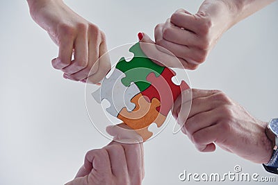 Group of business people assembling jigsaw puzzle